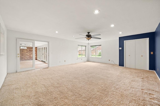 unfurnished living room with a ceiling fan, recessed lighting, and carpet