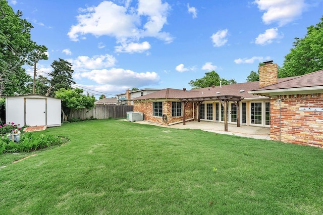 back of property with brick siding, a patio area, a shed, and fence