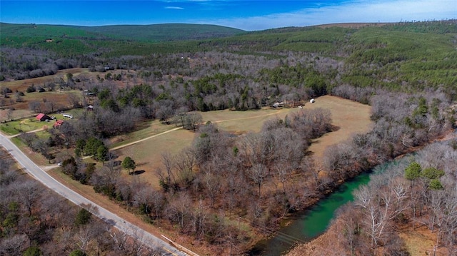 drone / aerial view with a mountain view and a forest view