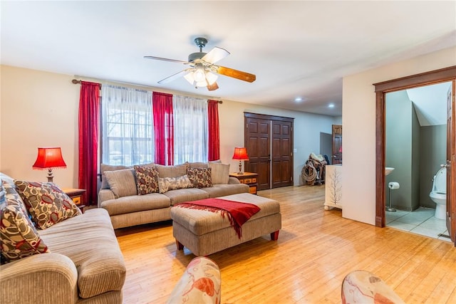 living area with ceiling fan and light wood-type flooring