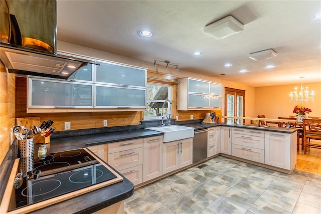 kitchen with an inviting chandelier, a peninsula, dark countertops, a sink, and dishwasher
