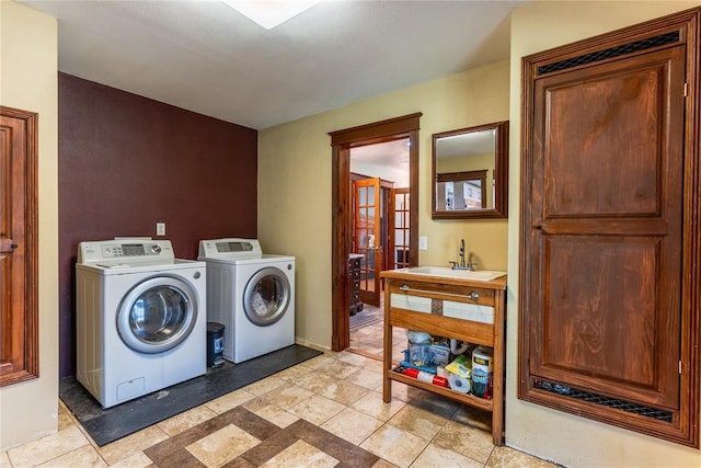 laundry room with laundry area, a sink, and washing machine and dryer