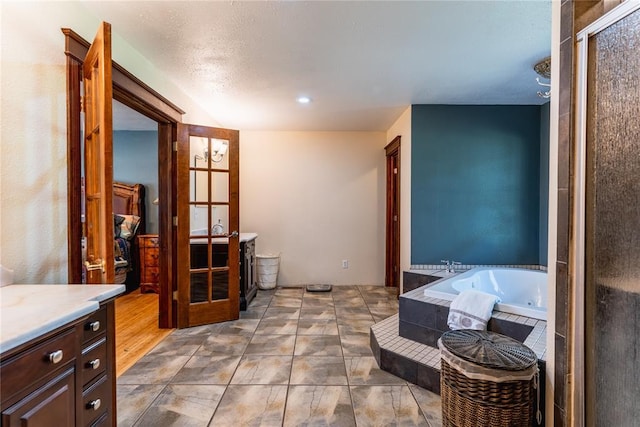 interior space with a shower stall, a bath, and vanity
