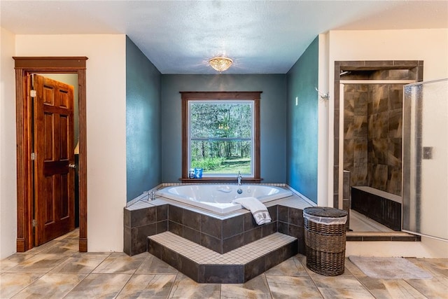 full bathroom featuring a shower stall and a garden tub