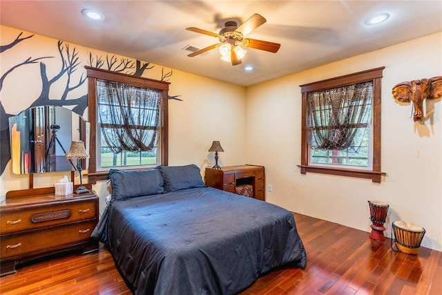 bedroom with ceiling fan, recessed lighting, wood finished floors, and visible vents