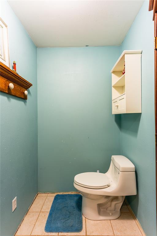 bathroom featuring tile patterned flooring and toilet