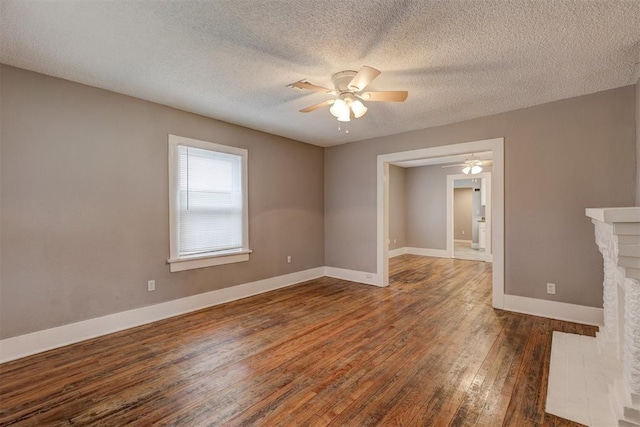 unfurnished room featuring baseboards, a textured ceiling, ceiling fan, and hardwood / wood-style floors