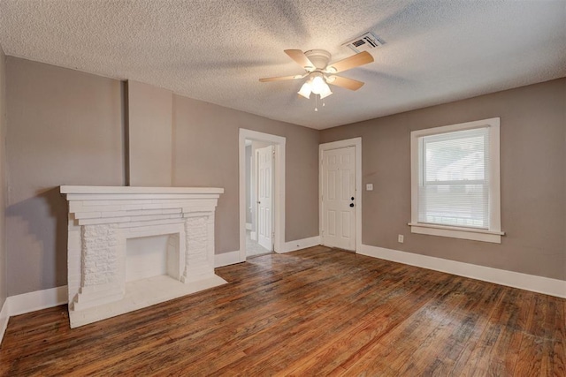 unfurnished living room featuring visible vents, a ceiling fan, baseboards, and wood finished floors