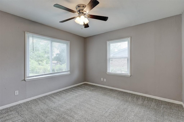 spare room with baseboards, carpet, and ceiling fan
