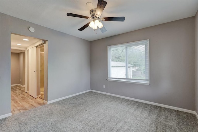 unfurnished room featuring baseboards, a ceiling fan, and carpet flooring