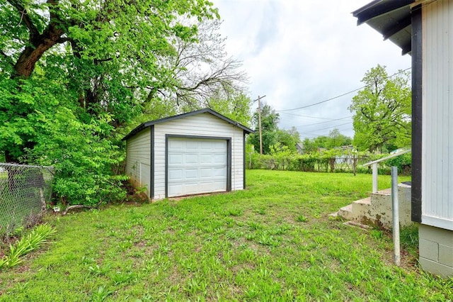 view of yard featuring fence and an outbuilding