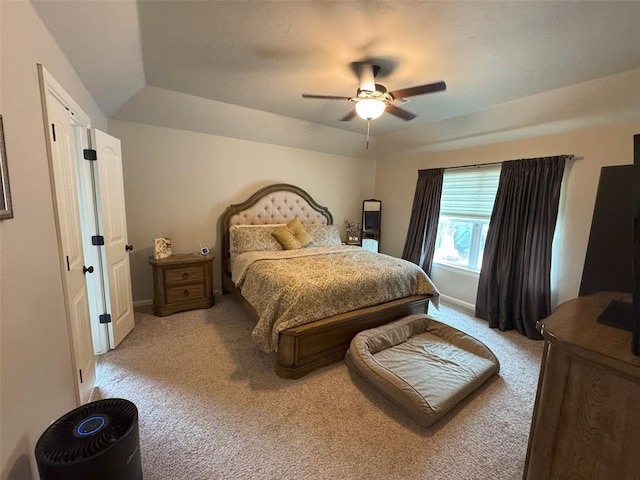 bedroom with light colored carpet, a ceiling fan, and baseboards