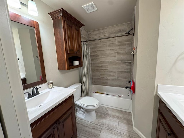 bathroom featuring visible vents, shower / bath combination with curtain, toilet, and vanity