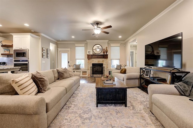 2201 Creek Side Cir, Moore, OK 73160 - living area featuring ornamental molding, a ceiling fan, a stone fireplace, recessed lighting, and light wood finished floors