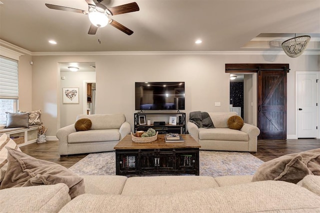 2201 Creek Side Cir, Moore, OK 73160 - living room with a barn door, baseboards, ceiling fan, wood finished floors, and ornamental molding