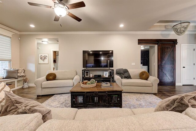 2201 Creek Side Cir, Moore, OK 73160 - living room with a barn door, baseboards, ceiling fan, wood finished floors, and ornamental molding