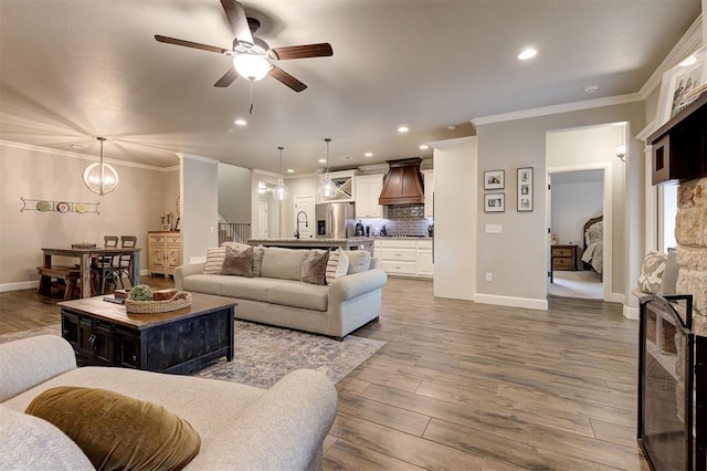 2201 Creek Side Cir, Moore, OK 73160 - living area with a ceiling fan, dark wood-style floors, recessed lighting, ornamental molding, and baseboards