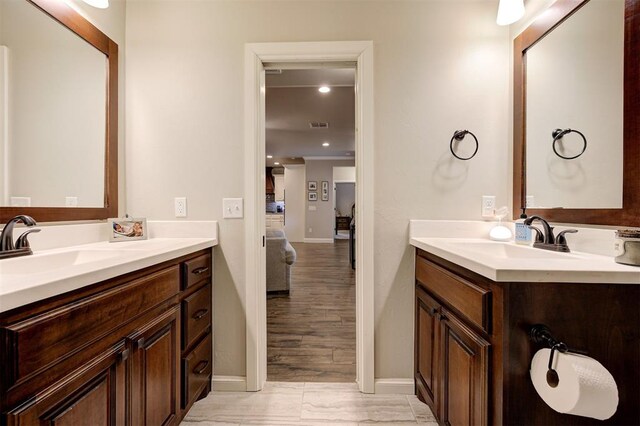 2201 Creek Side Cir, Moore, OK 73160 - bathroom featuring two vanities, baseboards, and ensuite bath