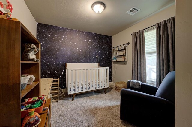 2201 Creek Side Cir, Moore, OK 73160 - bedroom featuring wallpapered walls, carpet floors, and a nursery area