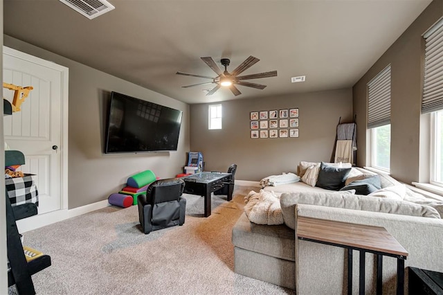 2201 Creek Side Cir, Moore, OK 73160 - living area featuring baseboards, a ceiling fan, and carpet flooring