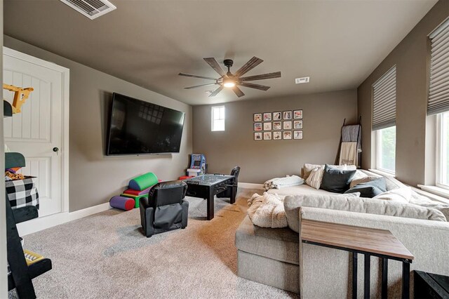 2201 Creek Side Cir, Moore, OK 73160 - living area featuring baseboards, a ceiling fan, and carpet flooring