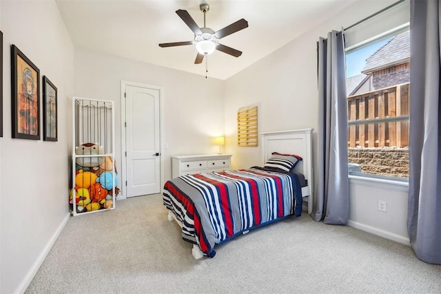 carpeted bedroom featuring baseboards and ceiling fan