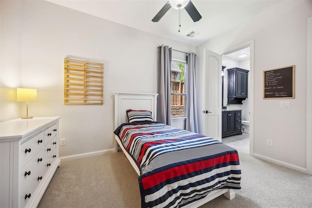 bedroom featuring visible vents, light carpet, baseboards, ensuite bathroom, and ceiling fan