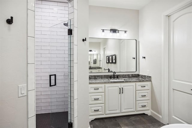 full bath with a shower stall and vanity