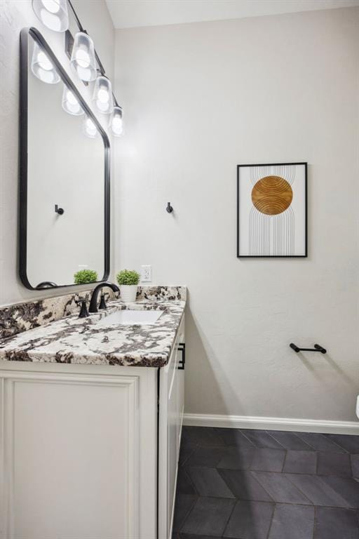 bathroom with vanity and baseboards