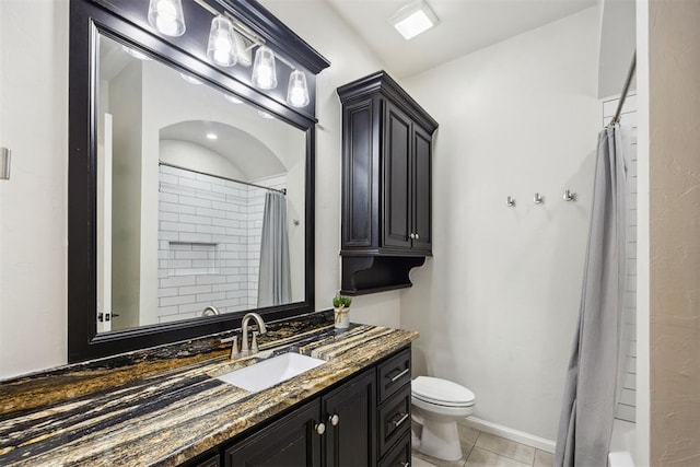 bathroom with tile patterned flooring, vanity, toilet, baseboards, and curtained shower