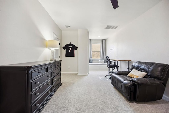 sitting room featuring visible vents, baseboards, ceiling fan, and light colored carpet