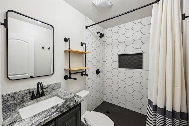 bathroom with vanity, a tile shower, toilet, and visible vents