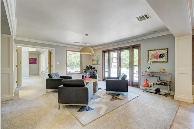 living area featuring crown molding, baseboards, visible vents, and light carpet