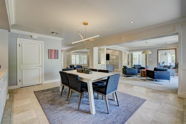 dining area featuring light tile patterned floors, ornamental molding, and a healthy amount of sunlight
