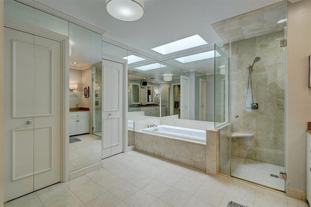 bathroom with a skylight, a shower stall, and a garden tub
