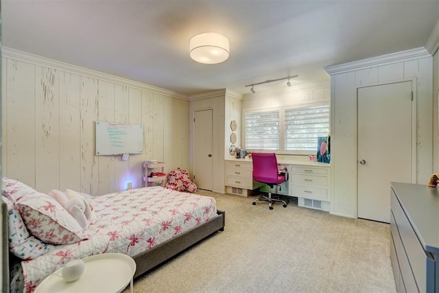 bedroom with carpet flooring, crown molding, and rail lighting