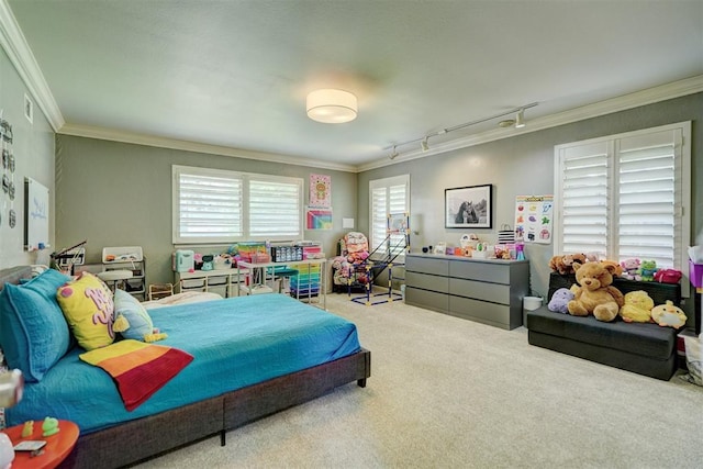 bedroom featuring carpet floors, ornamental molding, visible vents, and track lighting