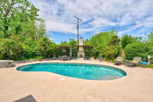 outdoor pool featuring a patio and an outdoor stone fireplace