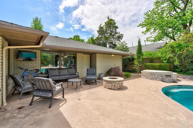 view of patio / terrace featuring a fenced in pool, a ceiling fan, an outdoor fire pit, and fence