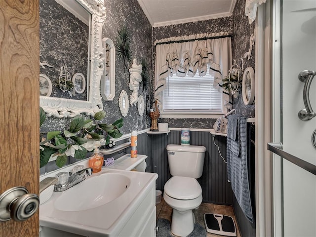 bathroom with tile patterned flooring, vanity, toilet, wallpapered walls, and ornamental molding