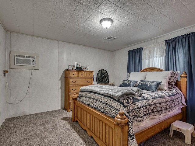 carpeted bedroom with visible vents and a wall mounted air conditioner