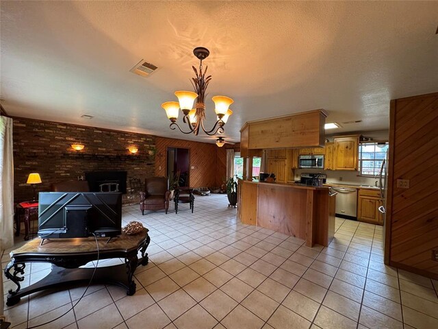 kitchen featuring light tile patterned floors, appliances with stainless steel finishes, visible vents, and open floor plan