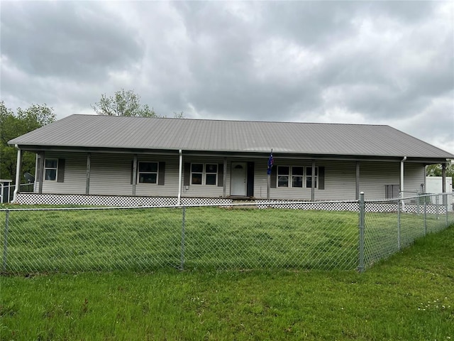 country-style home featuring a front lawn, fence, and metal roof