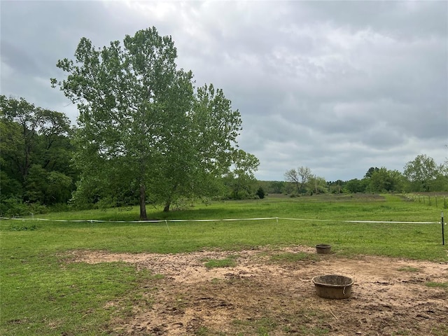 view of yard featuring fence and a rural view