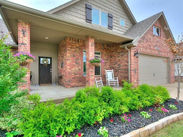 view of front of property featuring concrete driveway, a porch, and brick siding