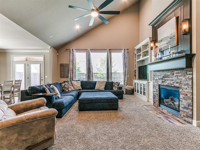 carpeted living area featuring ceiling fan, high vaulted ceiling, and a fireplace