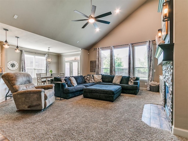 carpeted living room with baseboards, ceiling fan, a healthy amount of sunlight, and high vaulted ceiling