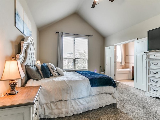bedroom with ensuite bathroom, a ceiling fan, light colored carpet, and lofted ceiling