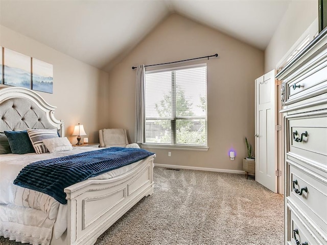 bedroom featuring baseboards, light colored carpet, and lofted ceiling