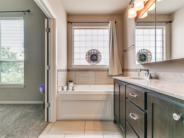bathroom featuring vanity, a garden tub, and tile patterned floors